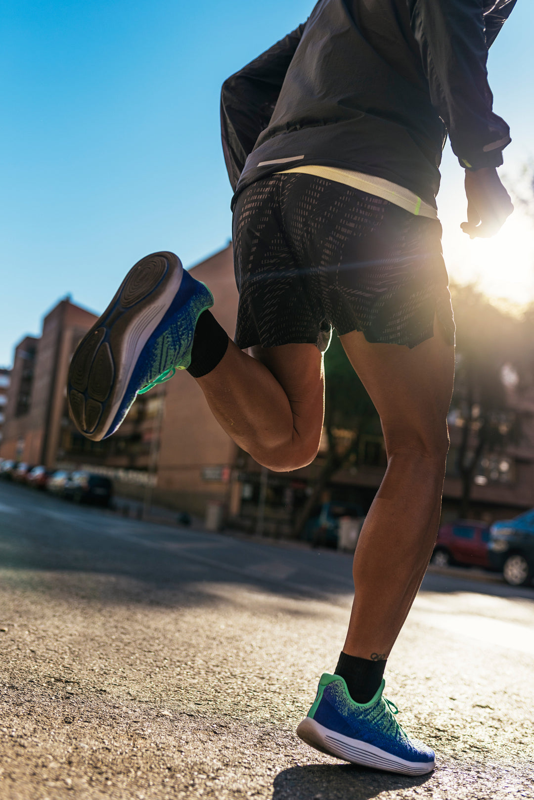 Beginner runner jogging outdoors during a 5K training session in built up surroundings