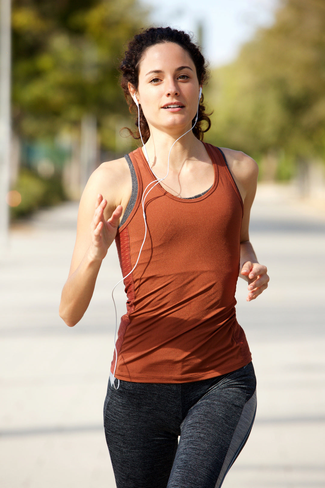 Runner moving along a quiet outdoor route during a tempo morning run in nature